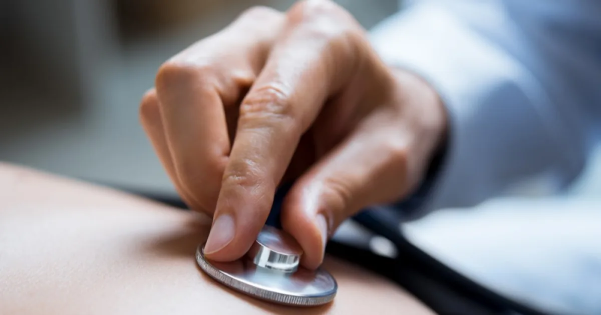 Physician listening with a stethoscope during an exam